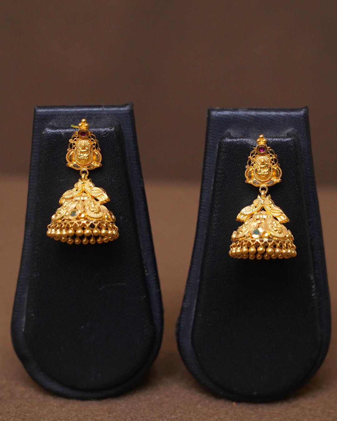 Traditional Gold Jhumka Earrings with Intricate Temple Design
