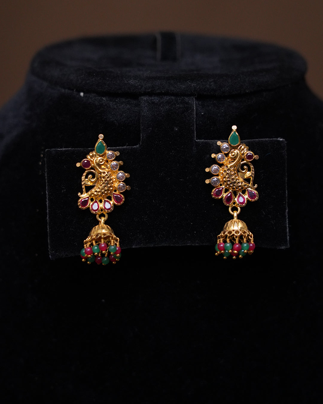 Traditional Peacock Design Gold Jhumka Earrings with Ruby & Green Beads